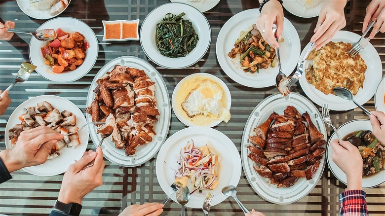 An overhead shot of a family dinner using white plates