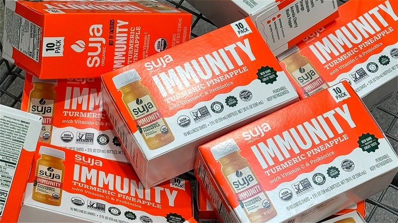 10-pack cases of Suja tumeric pineapple immunity shots in a Costco cart.
