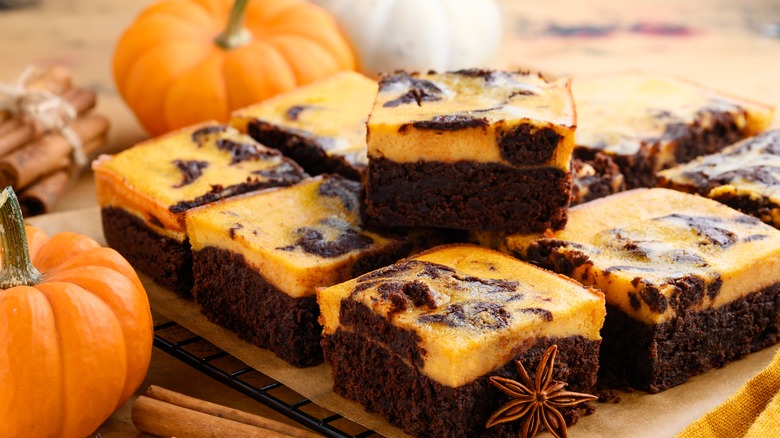 pumpkin brownies on a tray and pumpkins on the side
