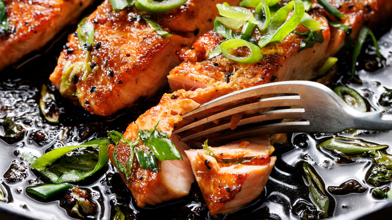 seared salmon garnished with sliced chives