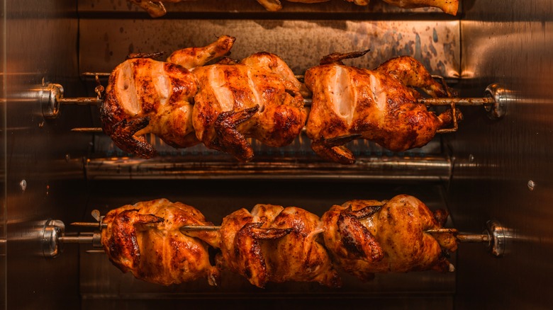 Rotisserie chickens being cooked