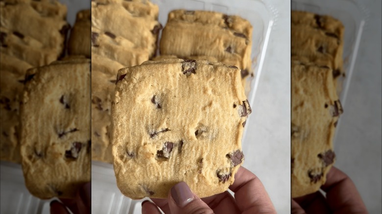 Person holding a Kirkland shortbread cookie with Belgian chocolate chunks.
