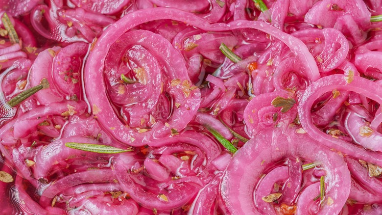 A closeup of pickled red onions