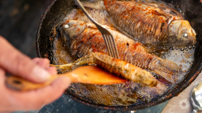Pan frying whole, seasoned fish