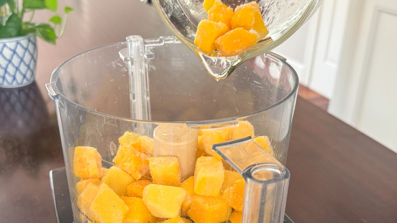 Mango chunks going into food processor