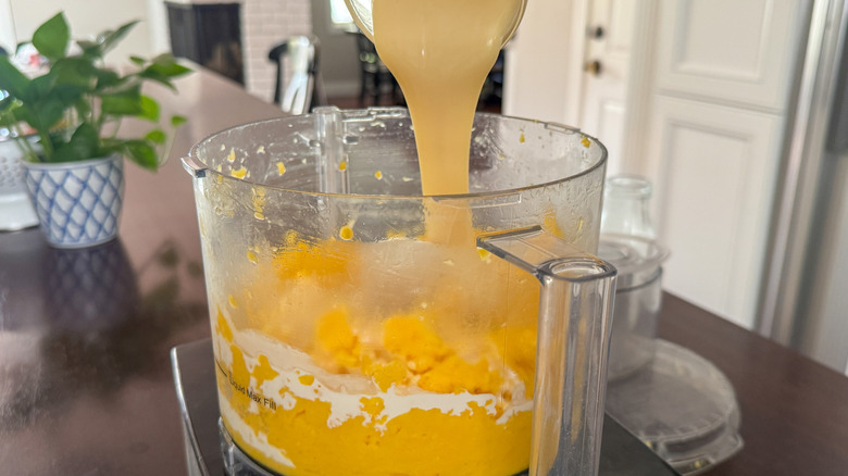 Sweetened condensed milk pouring into food processor