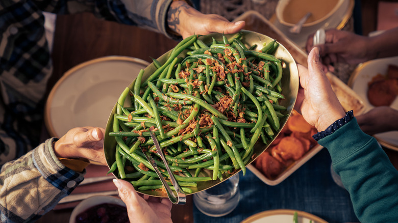 Family passing Green beans around a table