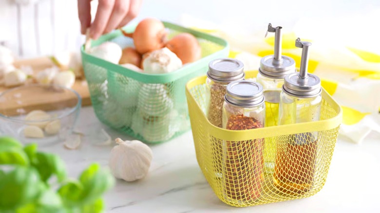 ikea 365+ food storage baskets containing onions, garlic, spices, and oil bottles