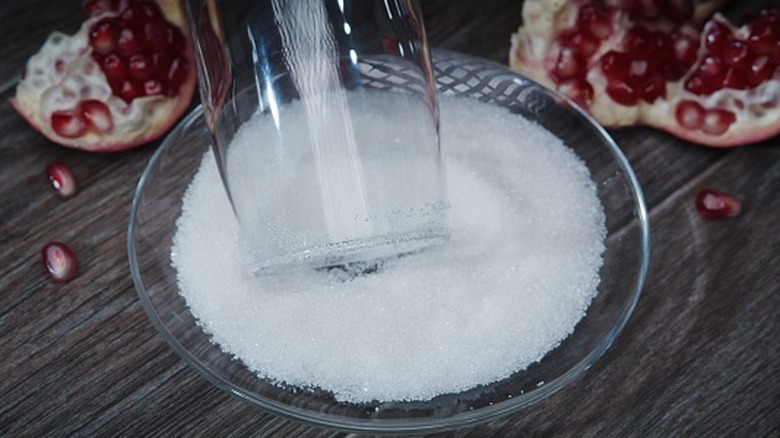 rimming a cocktail glass with sugar