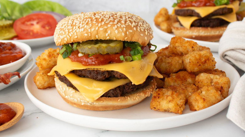 Cheeseburger on plate with tater tots