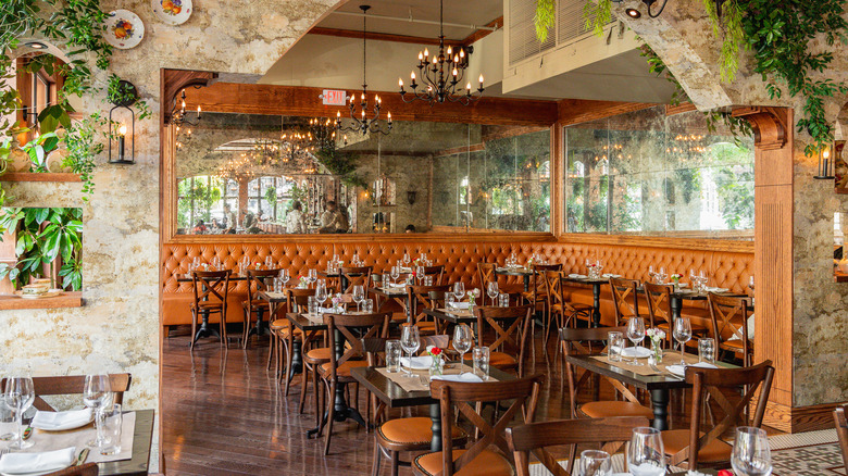 Set tables in the indoor dining room at Da Andrea