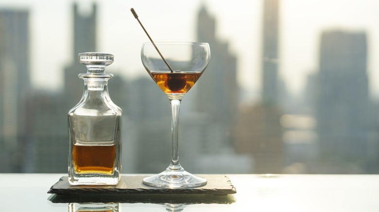 A small decanter and glass of bourbon