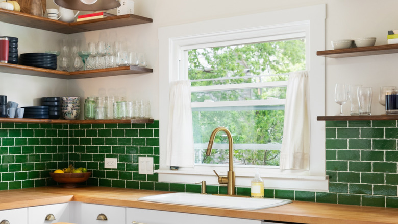 kitchen sink with pretty green backsplash