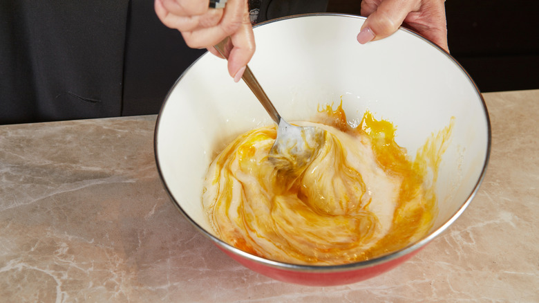 Mixing wet and dry ingredient together.