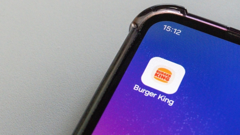 Burger king mobile app icon on smartphone screen close-up