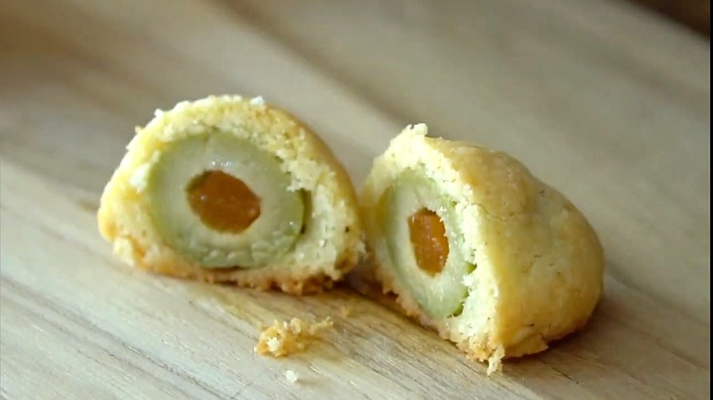 a olive cheese ball cut in half