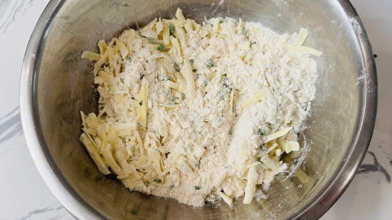 Dry cheese biscuit mixture in bowl