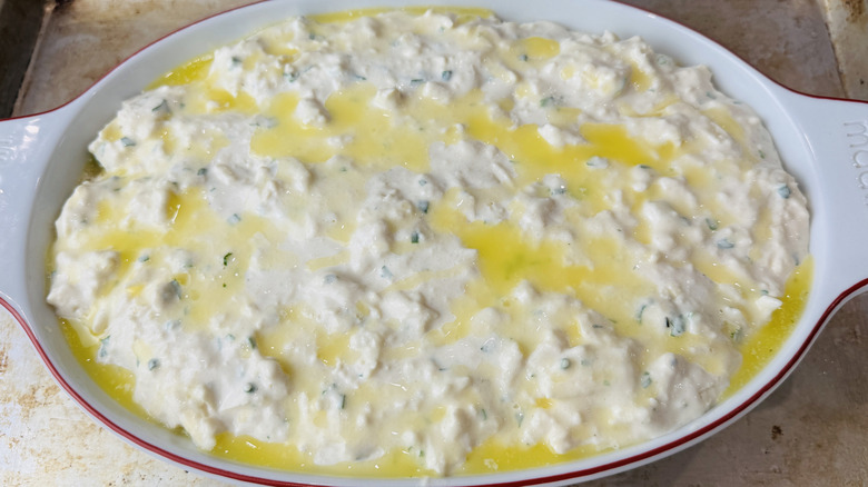 Butter drizzled over unbaked cobbler