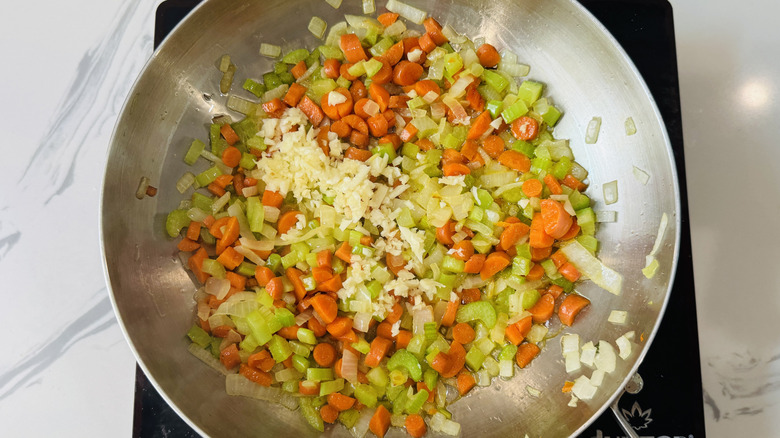 Mirepoix with garlic in skillet