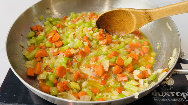 Stirring mirepoix with wine added
