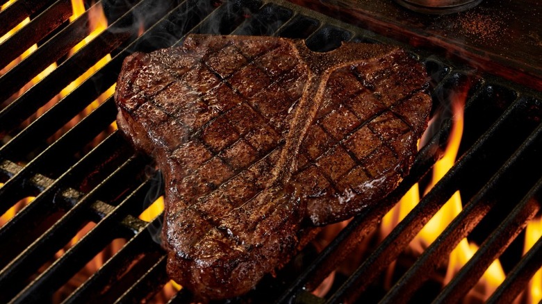 T-bone steak on a flaming grill