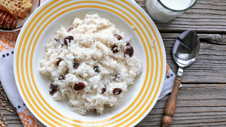 A bowl of rice pudding studded with raisins.