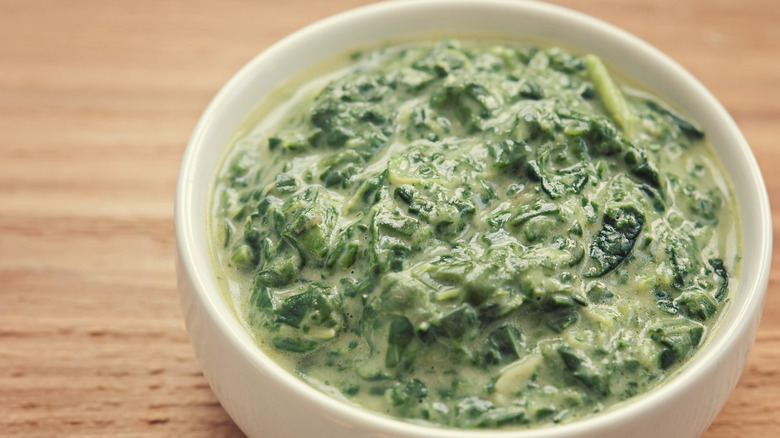 a bowl of creamed greens on a table