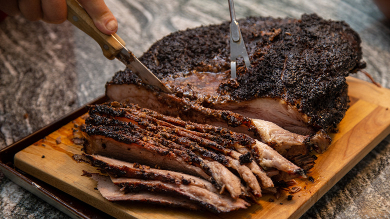 Sliced brisket resting on a cutting board.