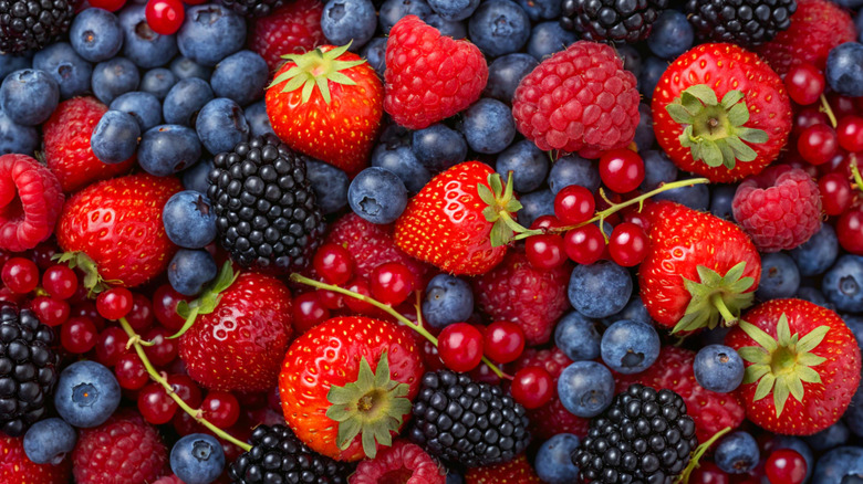 Pile of mixed berries with blueberries, strawberries, raspberries, and blackberries.
