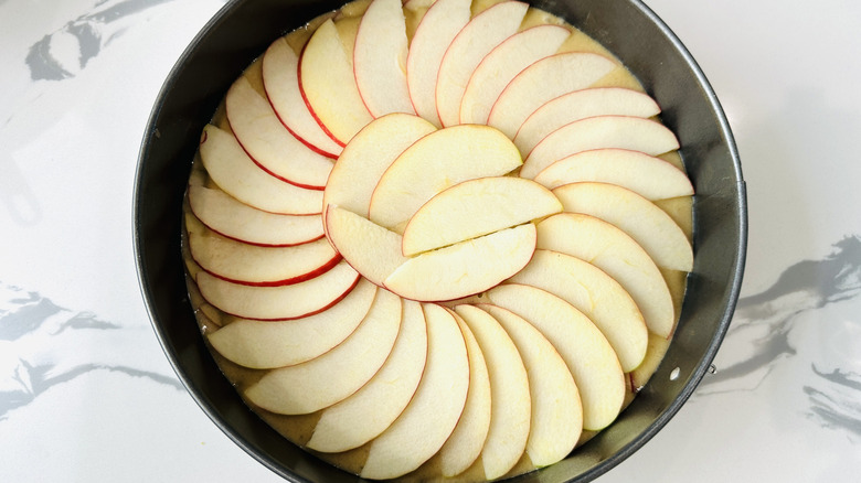 Apples fanned over cake batter