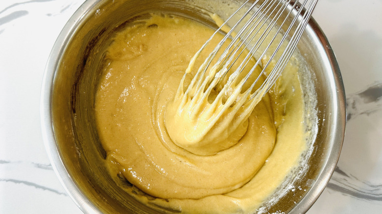 Whisking honey cake batter in bowl