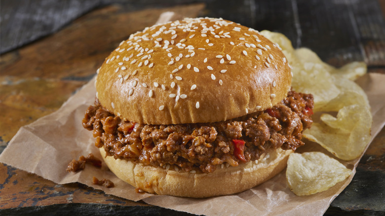 sloppy joe and potato chips on parchment paper
