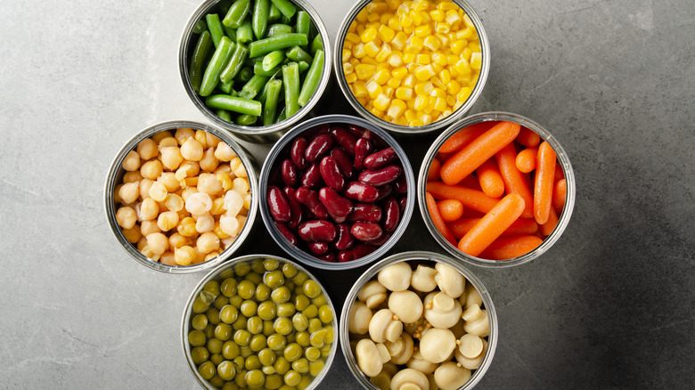 Top-down view of assorted open canned vegetables