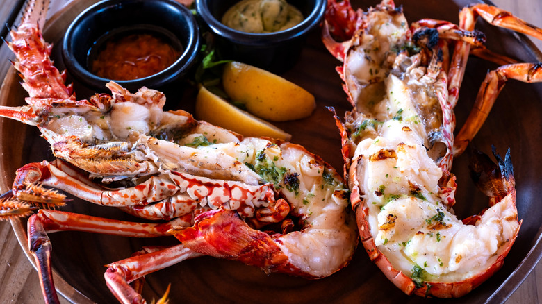 Lobster halves arranged on a plate.