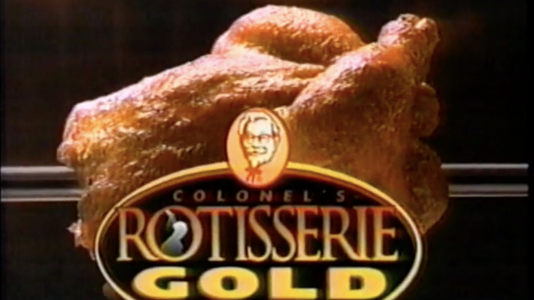 Colonel's Rotisserie Gold logo in front of a roasting rotisserie chicken