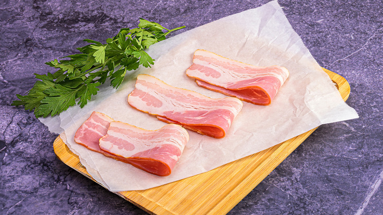 folded bacon on wooden tray