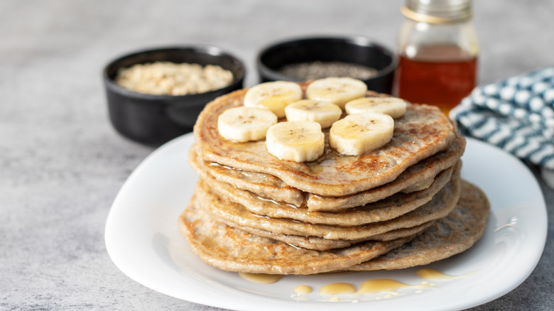 a close-up of banana and oat pancakes topped with jam