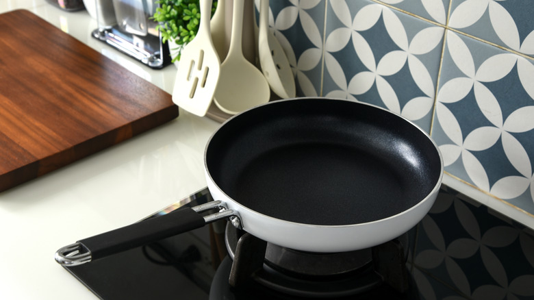 A nonstick pan on the stovetop in a modern kitchen.