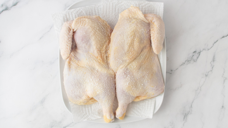 raw chicken on a white paper towel