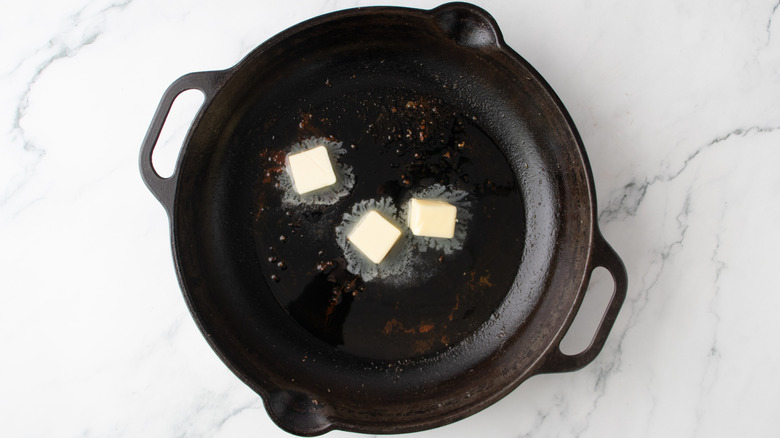 butter in a black frying pan