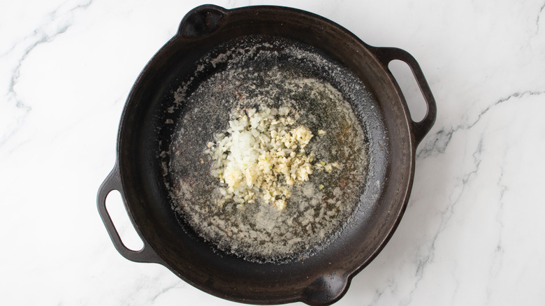 chopped onions in a black frying pan