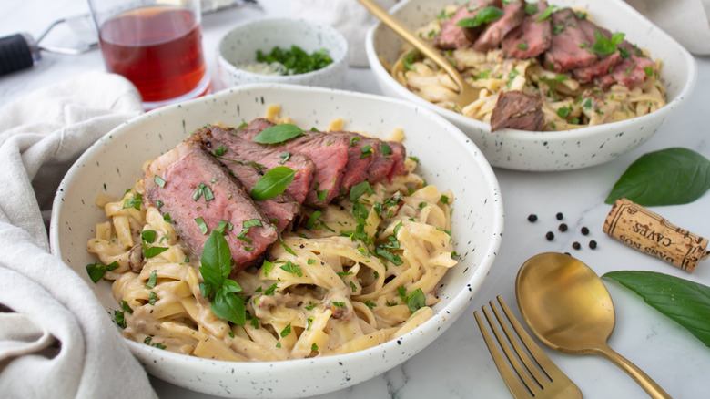 Steak Alfredo in two bowls
