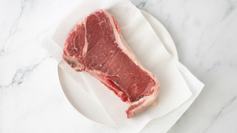 raw steak on paper towels