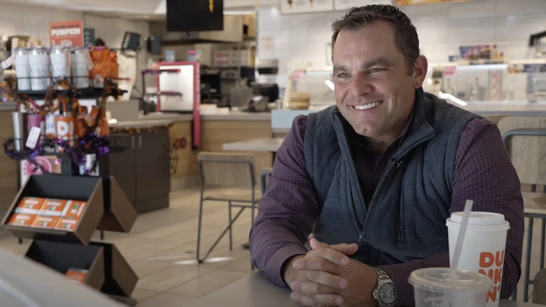 Kris Brown being interviewed in at one of the Dunkin' stores he owns