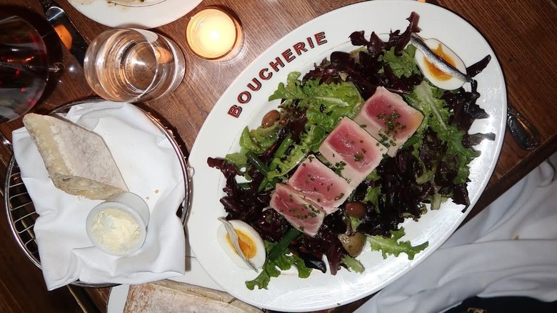 A flatlay of a salad from Boucherie topped with fresh tuna slices