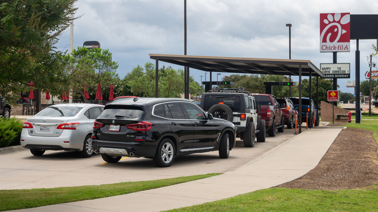 Customers wait in a Chick-fil-A drive thru.