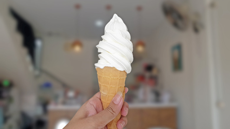 Person holding a soft serve cone