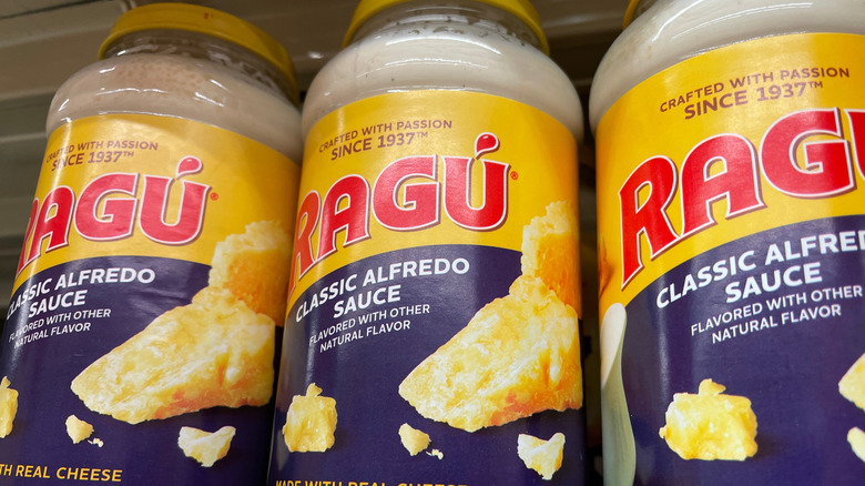 Jars of Ragú' Alfredo sauce on a store shelf
