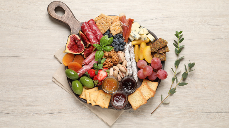 Charcuterie board on wood background