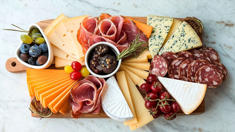 Charcuterie board on marble background